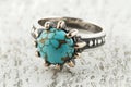 Ring with a blue stone in the center and gold accents Royalty Free Stock Photo