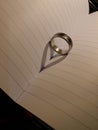 A ring on the book where the light refracts forms the shadow of a heart