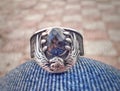 Silver ring of sliver Eagle captured an dark stone between his claws.