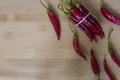 Ring of fire hot pepper with strong shadow on wooden background.