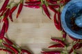 Ring of fire hot pepper with strong shadow on wooden background.