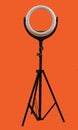 ring lamp on a tripod on bright red background Royalty Free Stock Photo