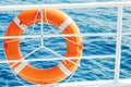 Ring life buoy on boat. Obligatory ship equipment. Orange lifesaver on the deck of a cruise ship. Royalty Free Stock Photo