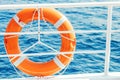 Ring life buoy on boat. Obligatory ship equipment. Orange lifesaver on the deck of a cruise ship Royalty Free Stock Photo