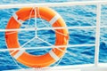 Ring life buoy on boat. Obligatory ship equipment. Orange lifesaver on the deck of a cruise ship Royalty Free Stock Photo