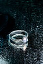 Ring with Moonstone on black background with water drops- Image