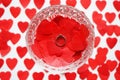 Ring on red hearts in a crystal glass on a white background with hearts Royalty Free Stock Photo