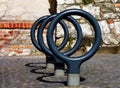 ring shaped heavy steel bicycle racks cast in cobblestone paving.