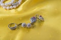 Ring and two pairs of earings on the yellow Royalty Free Stock Photo