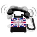 Ringing black stationary phone with rotary dial and flag of UK