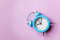 Ringing twin bell vintage classic alarm clock Isolated on purple violet pastel colourful background. Rest hours time of life good Royalty Free Stock Photo