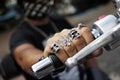 Rings on fingers holding motorcycle