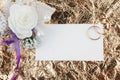 Rings, flowers and invitation on a gold background Royalty Free Stock Photo