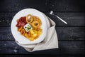 Rings of squid, onion rings, potato chips, salami chips with cheese sauce. Royalty Free Stock Photo