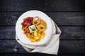 Rings of squid, onion rings, potato chips, salami chips with cheese sauce. Royalty Free Stock Photo