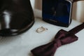 Rings, a tie, male shoe and a perfume on the table Royalty Free Stock Photo