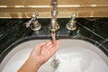 Rinse a woman left hand by luxury faucet Royalty Free Stock Photo