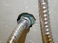 Rinsing spray hose connected to the water pipe, through a metalic joint with female - male thread