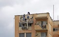 Workers repairing a building facade, Rio de Janeiro, Brazil