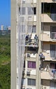 Workers repairing a building facade, Rio de Janeiro, Brazil