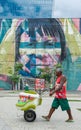 An ice cream peddler walks on the Olympic Boulevard, in the port zone of Rio de Janeiro