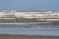 Local Brazilian fishermen fish net among large waves on the shore of the Atlantic Ocean