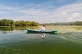 RIO DULCE, GUATEMALA - MARCH 10, 2016: Local indigenous woman paddling across Rio Dulce river, Guatema Royalty Free Stock Photo