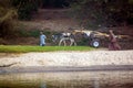 Rio Nilo, near Luxor, Egypt, February 21, 2017: Smiling Egyptian child carrying a loaded wagon and pulled by a donkey, with his fa