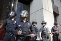 Riot police stand guard during Occupy LA march