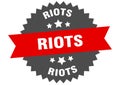 riots sign. riots round isolated ribbon label.