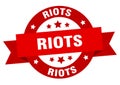 riots round ribbon isolated label. riots sign.