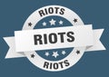 riots round ribbon isolated label. riots sign.