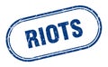 Riots stamp. rounded grunge textured sign. Label