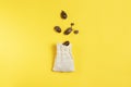 Ripe acorns fly into a linen bag on a yellow background copy space for text Royalty Free Stock Photo