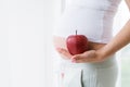 Ripe apple in hands of pregnant woman Royalty Free Stock Photo