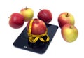 Ripe apple, kitchen scales and measuring tape isolated closeup Royalty Free Stock Photo