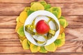 Ripe apple with measuring tape on plate and autumn leaves on the table. Top view. Healthy eating concept Royalty Free Stock Photo