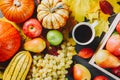 Ripe apples in a box with pumpkins, apples, grapes, pears and cup of coffee on dark wooden background. Autumn seasonal image. Top Royalty Free Stock Photo