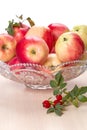 Ripe apples in a crystal vase and rose hips Royalty Free Stock Photo