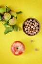 Ripe apples with a hazelnut pial on a yellow background. Healthy breakfast Royalty Free Stock Photo