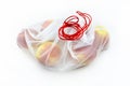 Ripe apples packed in a white reusable mesh bag with red string, isolated on a white background. Royalty Free Stock Photo