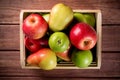 Ripe apples and pears in a wooden box on dark brown wooden rustic background. Autumn seasonal image with top view Royalty Free Stock Photo