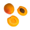 Ripe apricot fruits, one whole and divided into pieces, on a white background in isolation Royalty Free Stock Photo