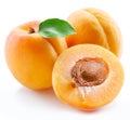 Ripe apricots with green leaf and apricot half isolated on white background Royalty Free Stock Photo