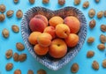 Ripe apricots and peaches in heart-shaped plate