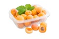 Ripe apricots in plastic tray and several apricots separately cl Royalty Free Stock Photo