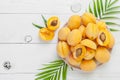 Ripe apricots on a round plate on a white board table. Flat-lay Royalty Free Stock Photo