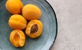 ripe apricots whole and halves on a plate