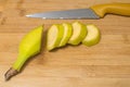 Ripe banana on a wooden board. Juicy sweet banana slices on wooden board