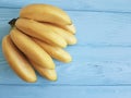 Ripe bananas exotic on a blue wooden background Royalty Free Stock Photo